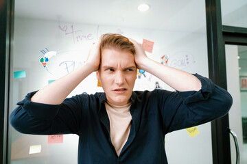 Portrait of young businessman frustrated, worried, disappointed, fail face expression while...