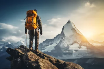 Poster Hiker with backpack and trekking poles standing on a mountain peak © gographic