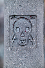 stamped skull an bones danger sign on electric concrete pole