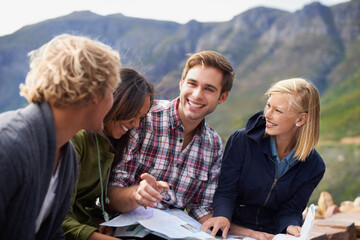 Happy people, friends and map in nature for travel, location or discussion on destination. Young...