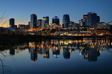 Panoramic view of a city skyline at twilight With lights beginning to twinkle in the buildings Reflecting a vibrant urban life