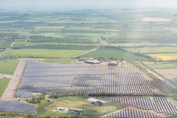 Large scale solar farm in rural landscape showing panels situated on farmland
