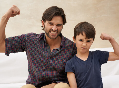 Sofa, muscle and portrait of father and child flex for bonding, fun childhood and relax together. Family, home and strong dad with young son on couch for love, care and support in living room