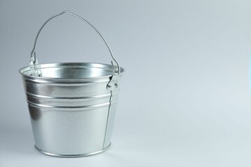 One shiny metal bucket on white background. Space for text