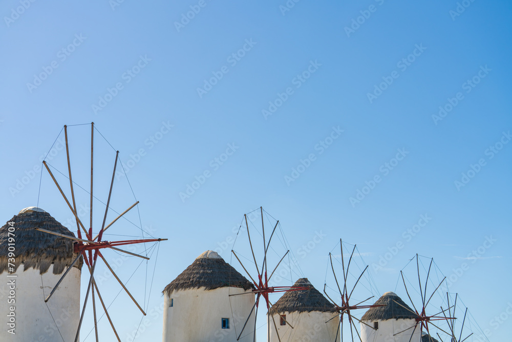 Poster Partly seen Famous Windmills of Mykonos town with clear blue sky. Mykonos Island in Greece