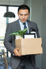 Businessman looking sad after getting fired from his job