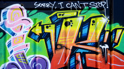 Colorful background of graffiti painting artwork with bright aerosol outlines on wall. Old school...