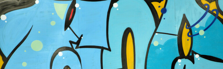 Colorful background of graffiti painting artwork with bright aerosol outlines on wall. Old school...