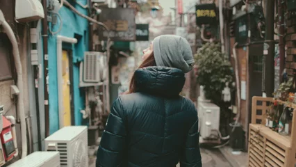 Deurstickers Tourist girl explore Japanese culture walking small old Tokyo street. Back view © Anastasia Pro