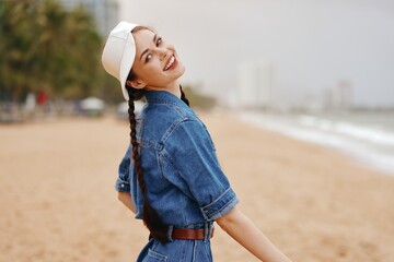 Summer Style: Attractive Young Female Model Posing outdoors in a Blue Hat with a Beautiful Sunset City Beach Background