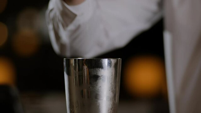 Bartender opening up a cocktail shaker