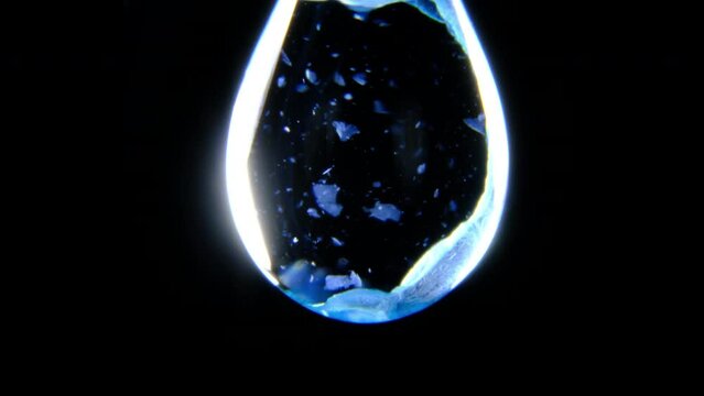 Copper Hydroxide Precipitates in a water drop through a chemical reaction between copper sulphate and sodium hydroxide