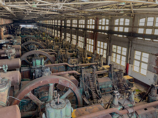Interior image of the long factory floor with the heavy equipment and machinery used in the early...