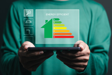 Energy efficiency concept. energy efficient house building rate label audit  for sustainable development. Person use smartphone with energy efficiency rating on virtual screen.