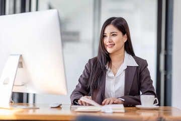Asian woman working with Blank screen desktop computer in the office