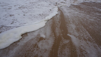 Background image pattern of sea shore with sea waves on sand