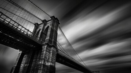 A Dramatic Black and White Shot of a Modern Bridge Against a Backdrop of Clouds, Enshrouded in Nighttime Mystique - obrazy, fototapety, plakaty