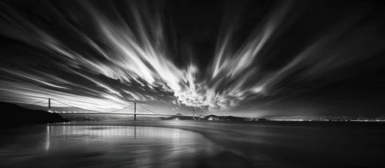 Zelfklevend Fotobehang A Dramatic Black and White Image of a Modern Bridge Reflecting in Water, Adorned with Clouds, Enveloped in Mystique © MdMohammod