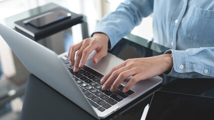 Businesswoman working on laptop computer at office. Business woman using portable computer, surfing the internet, searching the information, online working, e-learning concept