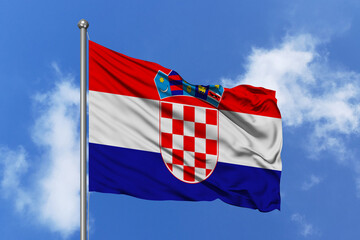Naklejka premium Croatia flag fluttering in the wind on sky.