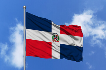 Dominican Republic flag fluttering in the wind on sky.