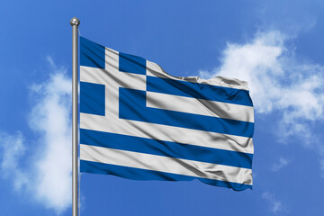 Greece flag fluttering in the wind on sky.