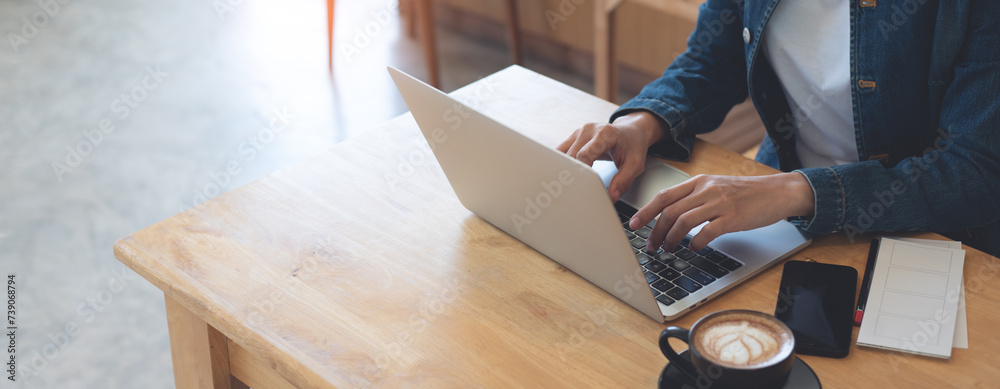 Poster business woman working on laptop computer in coffee shop, freelance at work. businesswoman in casual