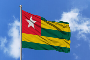 Togo flag fluttering in the wind on sky.