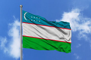 Uzbekistan flag fluttering in the wind on sky.