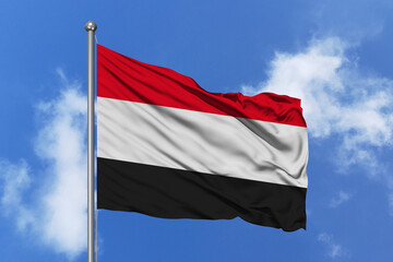 Yemen flag fluttering in the wind on sky.