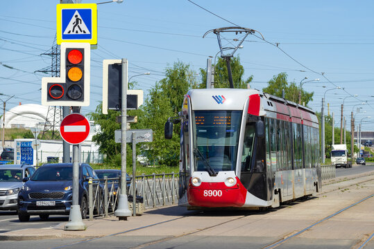 SAINT PETERSBURG, RUSSIA - JUNE 04, 2021: Tram 71-801 (Alstom Citadis 301 CIS) at a traffic light on a sunny June day