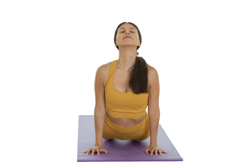 Frontal image of a young woman doing the cobra pose, while practicing yoga in a studio