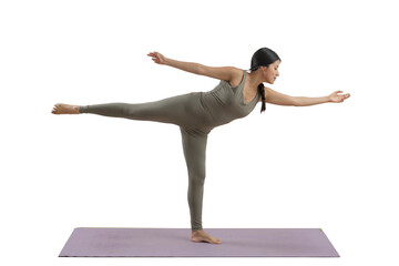 Young mexican woman practicing yoga indoors, standing doing a pose