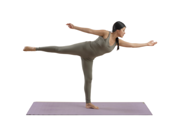 Young mexican woman practicing yoga indoors, standing doing a pose