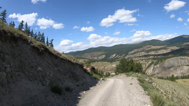 Driving on off-road car along a mountain serpentine road. Yazula mountain pas in Altai