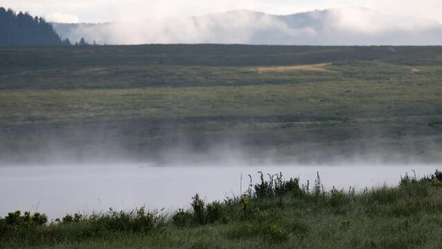 Video of morning fog over water. Lake Chagakol is one of the mountain Ulagan lakes.