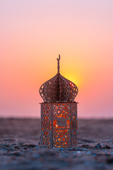 Islamic concept image, Beautiful lantern on the beach with sunset sky, Ramadan Kareem background