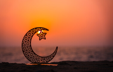 Sunset beach with crescent moon shape, Ramadan Mubarak background, Eid Mubarak greeting image with copy space