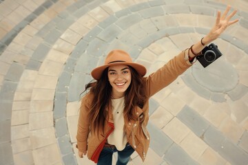 Traveling photographer with a friendly wave and camera