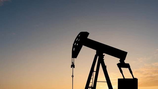 Timelapse of oil rigs at sunset. Oil industry