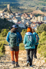 Fototapeta premium Back view to people hiking outdoors