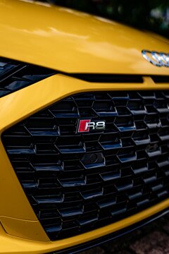the front grille of an audi r9 yellow with black highlights and rps badge