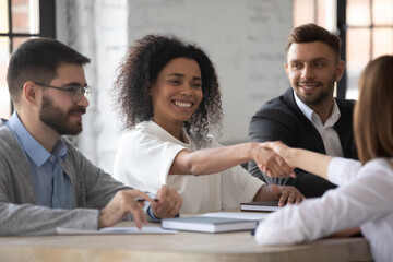 Business ethics and etiquette. Gender and ethnic diversity at work. Smiling young African-American...
