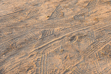 motorcycle and car tire track print on sand with selective focus