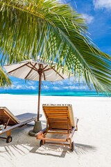 Beautiful tropical beach leisure banner. Couple chairs umbrella white sand coco palm trees travel honeymoon wide panorama background. Amazing landscape. Luxury island resort vacation, sunshine sea sky