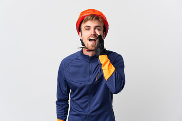 Young cyclist blonde man isolated on white background shouting with mouth wide open