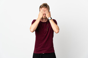 Young handsome man isolated on white background covering eyes by hands