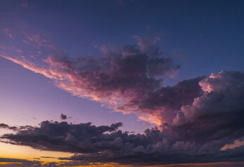 Fototapeta premium Dramatic Evening Sky with Time-Lapse Clouds at Sunset and Night, showcasing a beautiful blend of orange, red, and dark hues, creating a captivating and abstract cloudscape