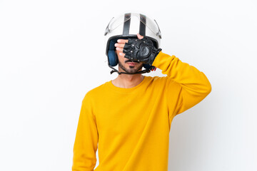 Young caucasian man with a motorcycle helmet isolated on white background covering eyes by hands. Do not want to see something