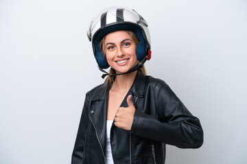 Young caucasian woman with a motorcycle helmet isolated on white background giving a thumbs up...